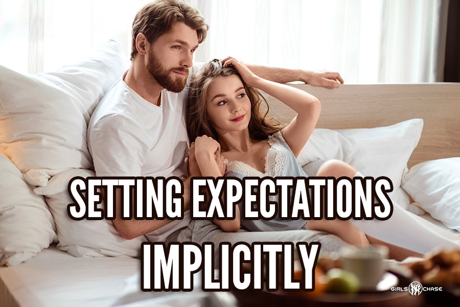 man and woman sitting together happily in bed