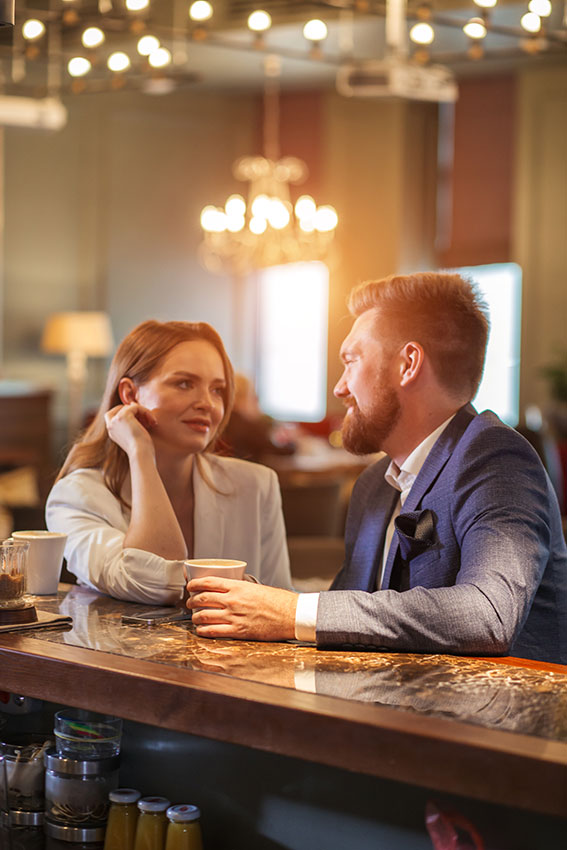 man and woman flirting at bar